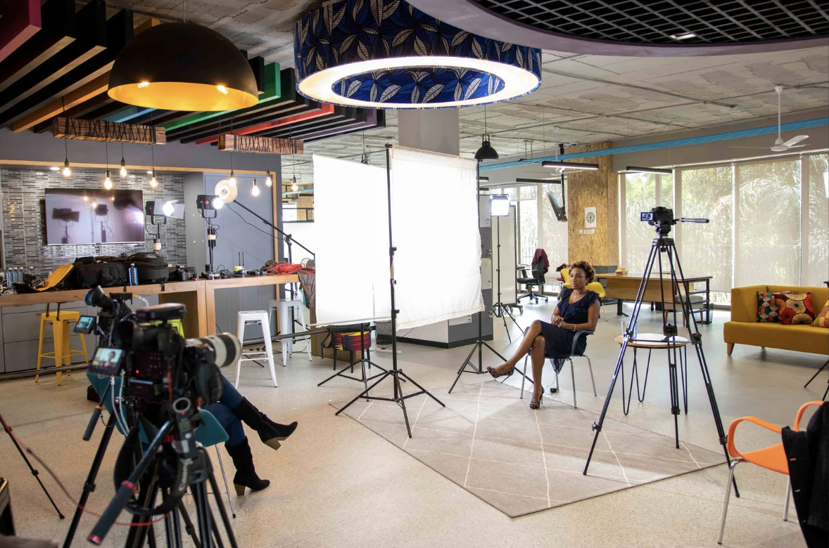 Crew filming an on-camera interview inside a client office